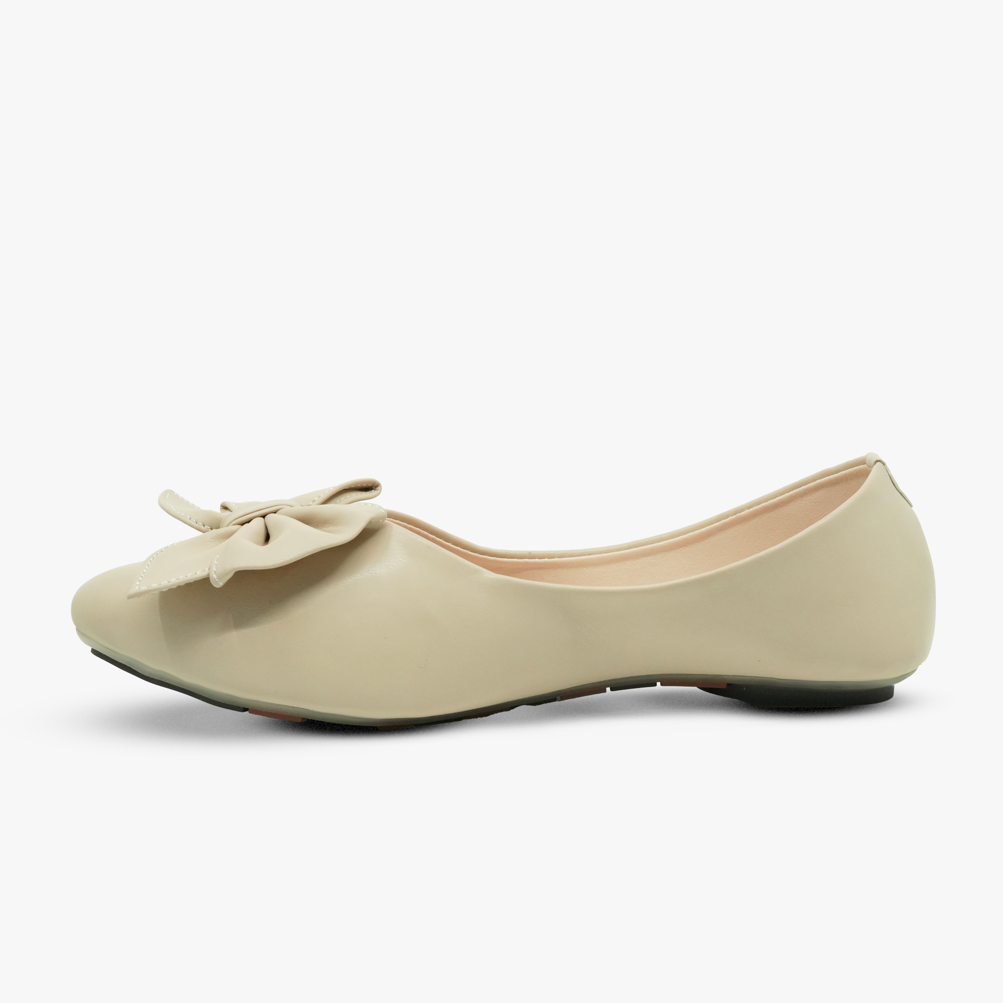 “Profile shot of beige ballet flats with a decorative bow on the vamp”