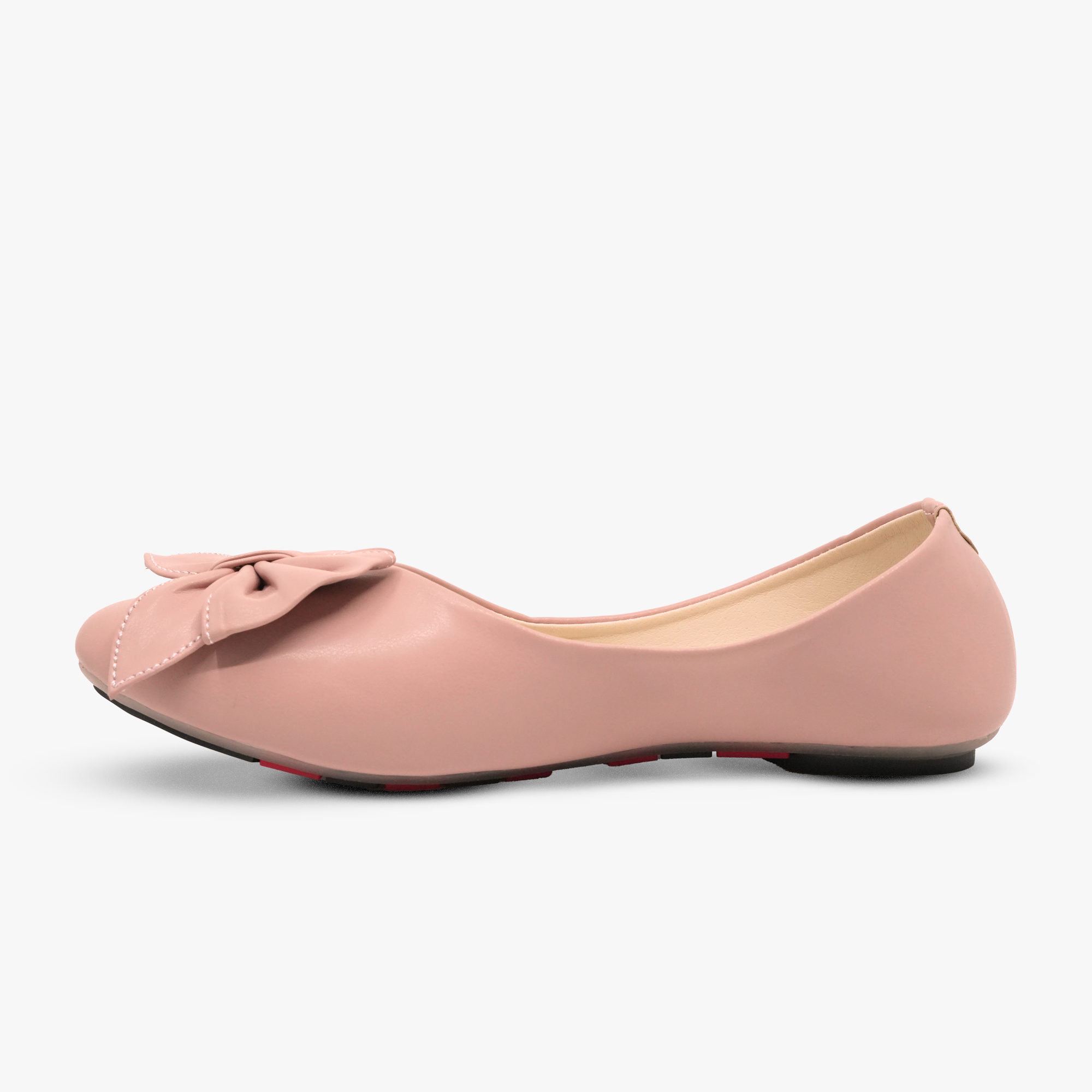 “Profile shot of pink ballet flats featuring a decorative bow on the vamp”