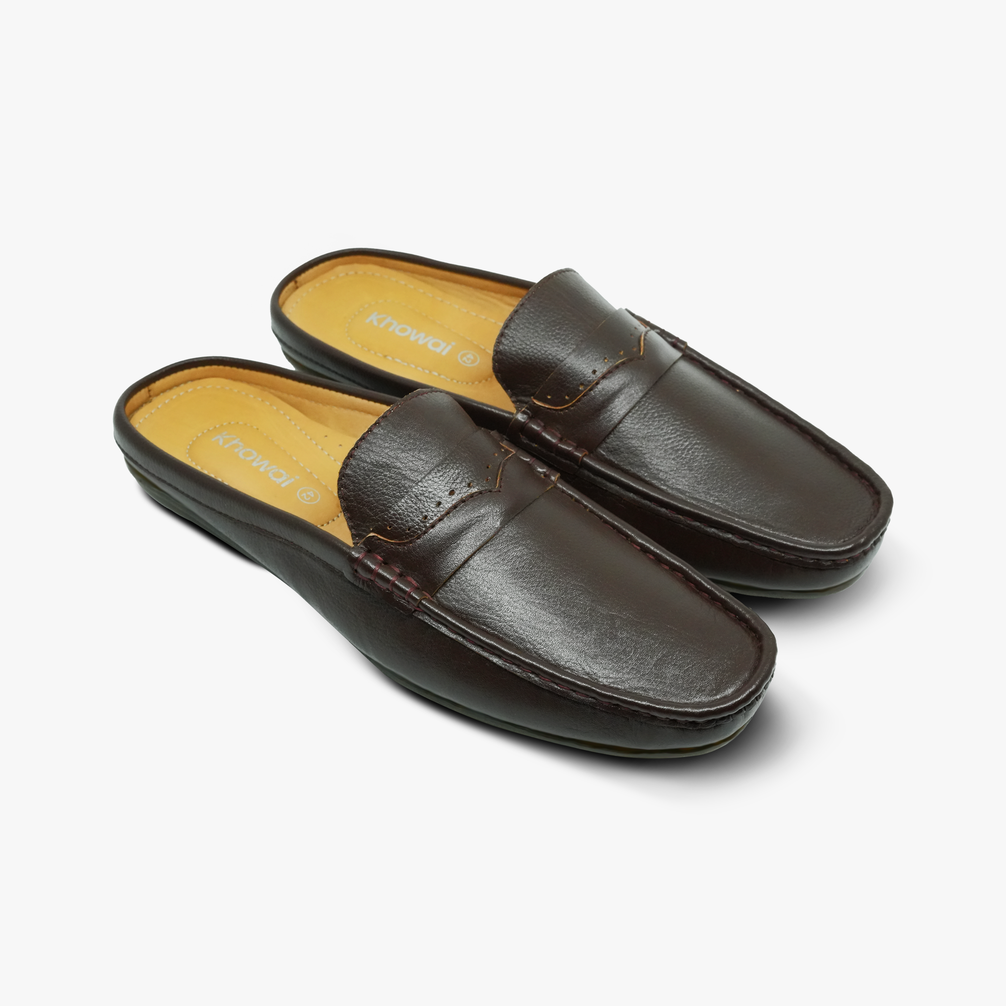 “Front angle of two Khowai brown mule loafers showing penny strap detail”